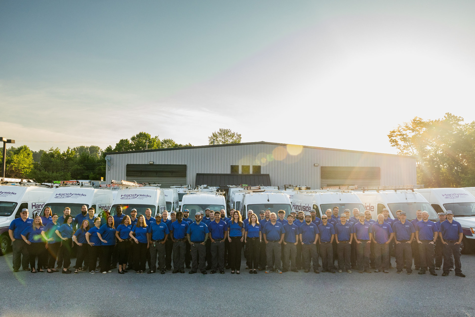 The Handyside team of HVAC, electrical, and plumbing technicians with their service vans